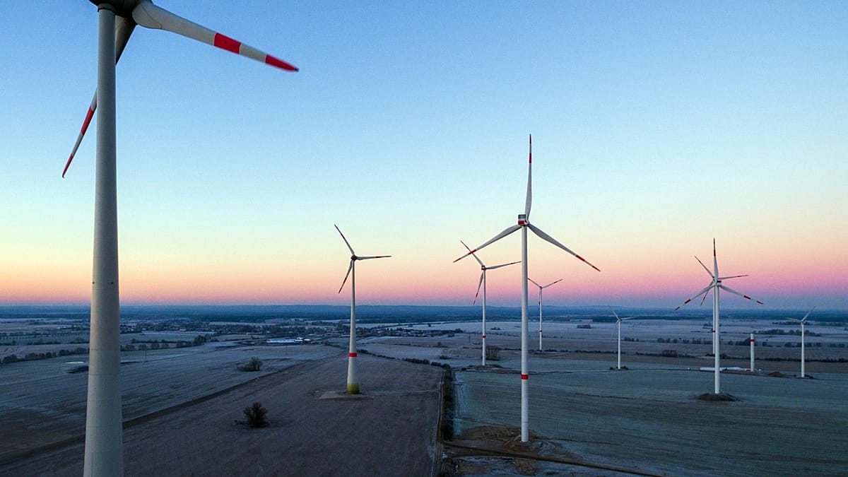 Industrial scale battery storage containers in a solar farm setting under bright sun