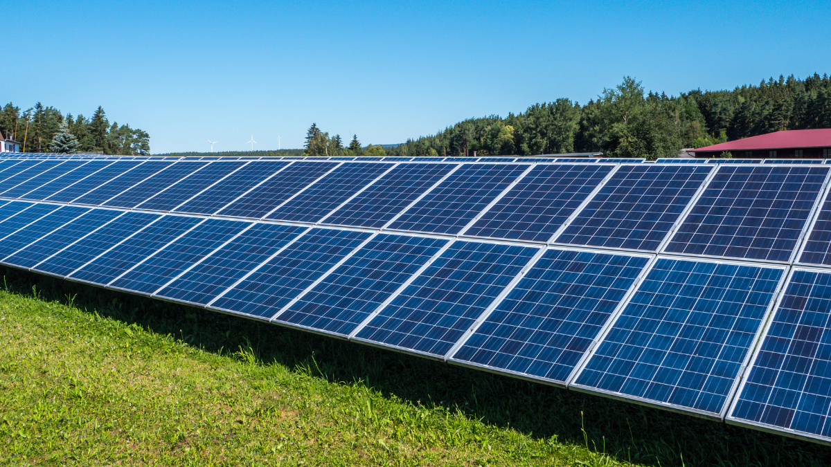 Aerial view of a large-scale solar park with battery containers