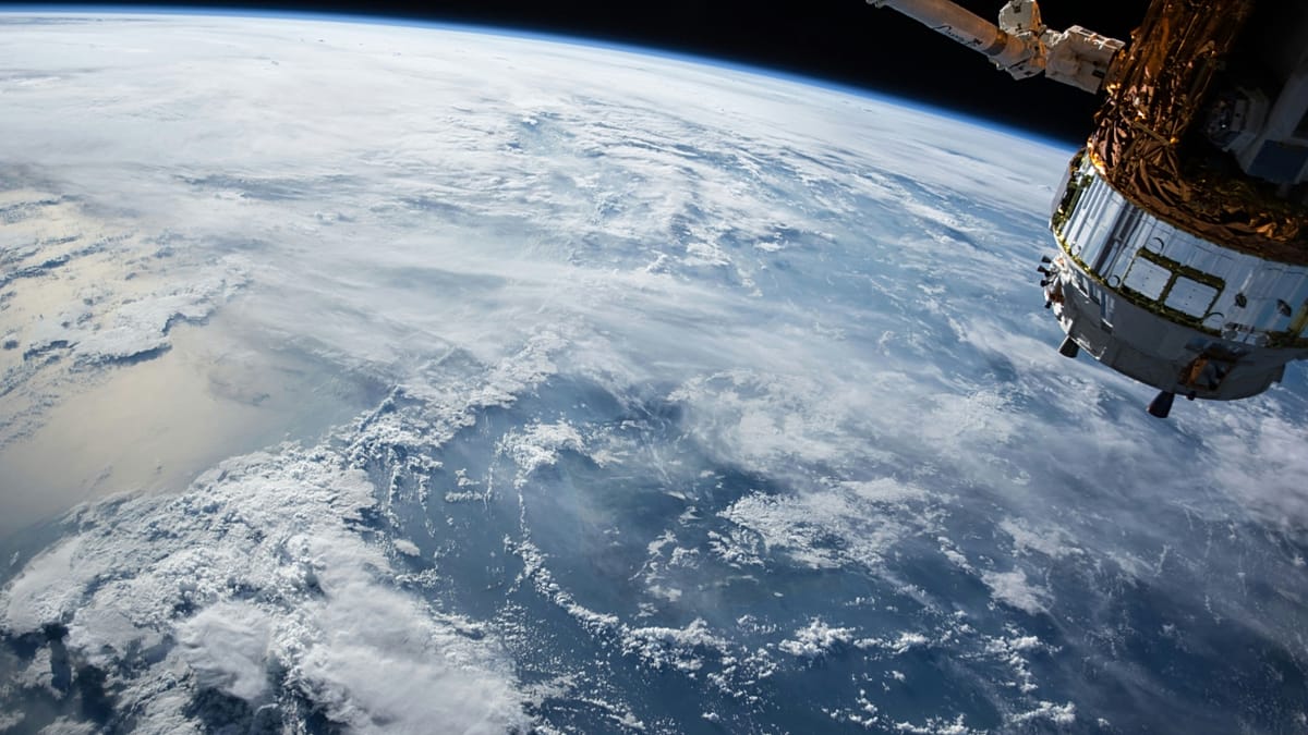 A futuristic artist's rendering of solar panels in orbit beaming energy to a European city.