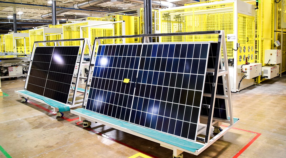 A modern solar cell manufacturing line with robotic arms handling silicon wafers