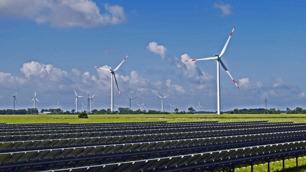 Large scale utility solar farm in a desert landscape with thousands of shimmering PV panels.