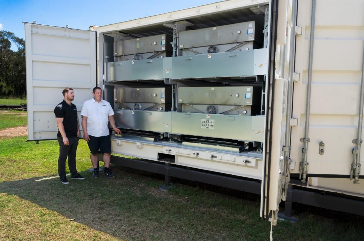 A grid-scale battery storage facility with specialized thermal management housing.