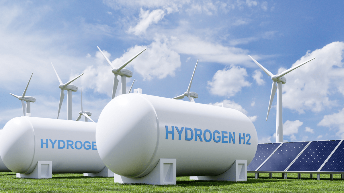 Industrial green hydrogen electrolyzer facility powered by nearby solar and wind farms in Denmark.