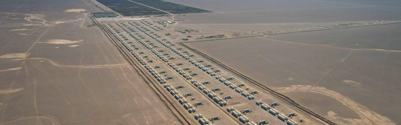 Large scale battery energy storage system containers in a desert environment under a night sky