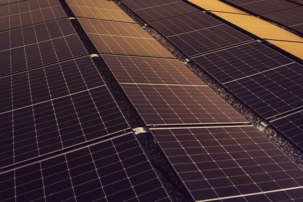 A technical drawing of a PV array layout on a desk with a pair of calipers and a Spanish engineering seal.