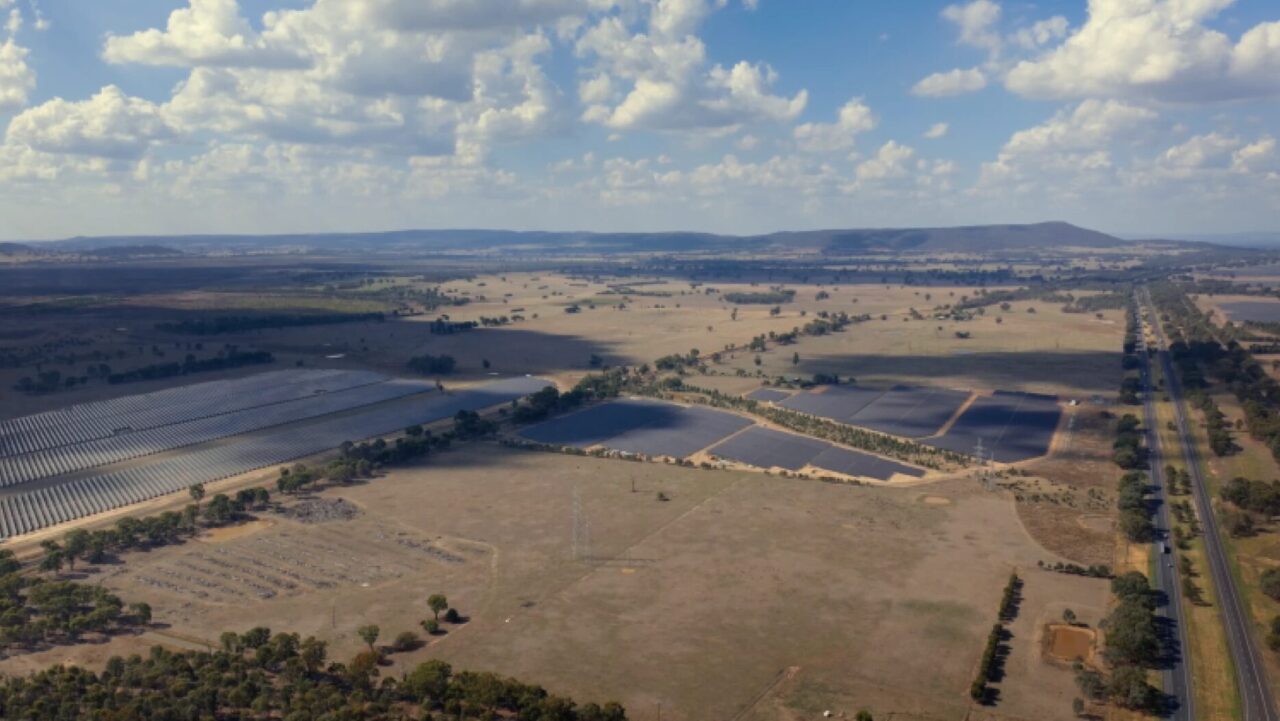 Aerial view of a large-scale solar farm integrated with battery energy storage systems.
