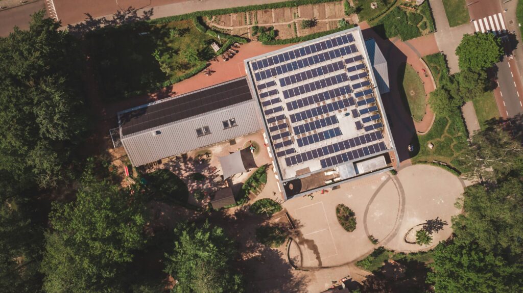 Workers installing solar panels on a school roof in the Murcia region of Spain