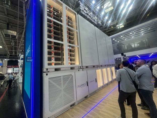 A row of Fluence Gridstack battery storage units at a large scale energy project.