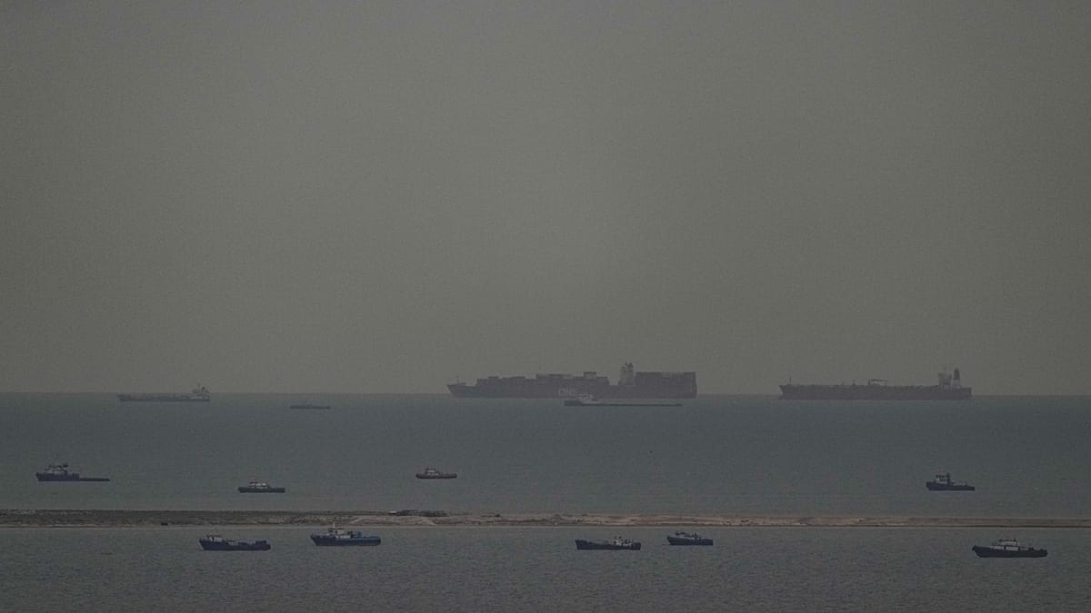 A tanker ship navigating narrow waters with a graphic overlay of rising energy price charts.