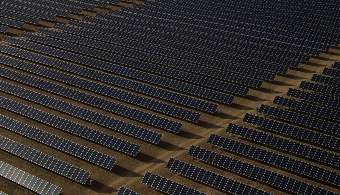 A conceptual image showing paperwork and solar panels, symbolizing permitting bureaucracy for renewable energy.