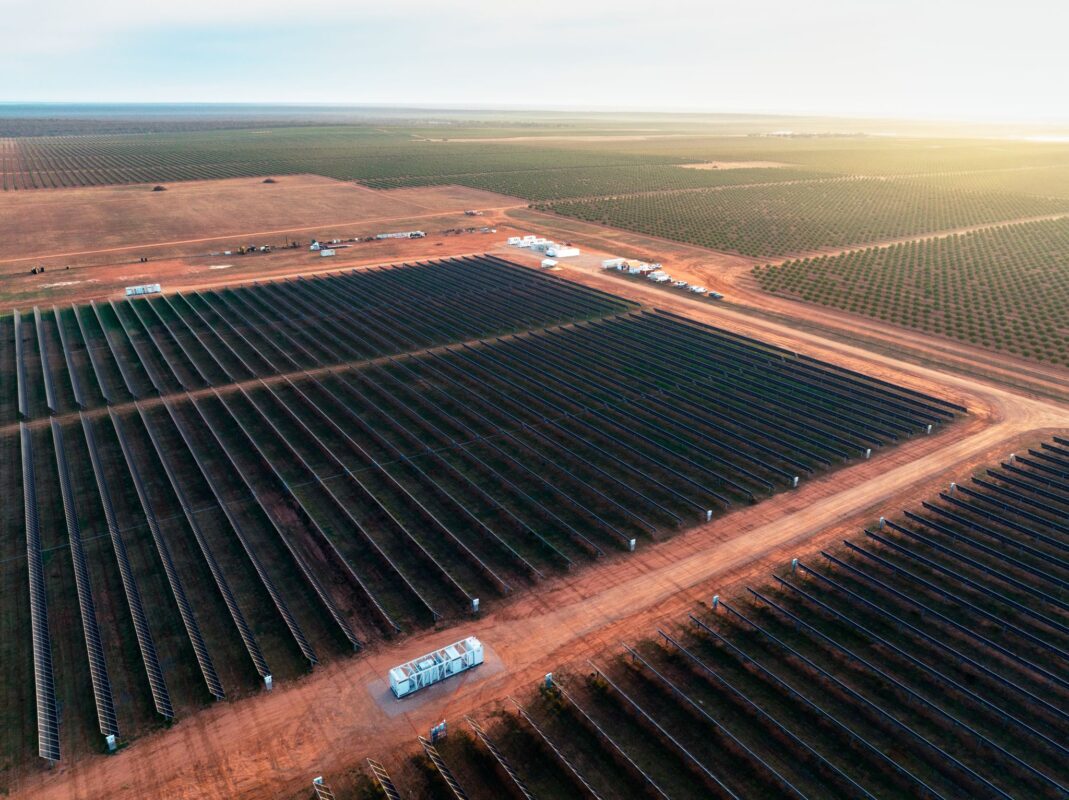 Aerial view of a large-scale solar microgrid integrated with agricultural land