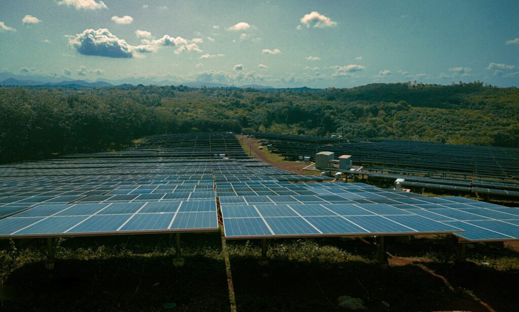 A utility-scale solar farm in Spain featuring large-scale battery energy storage systems during a sunny day.