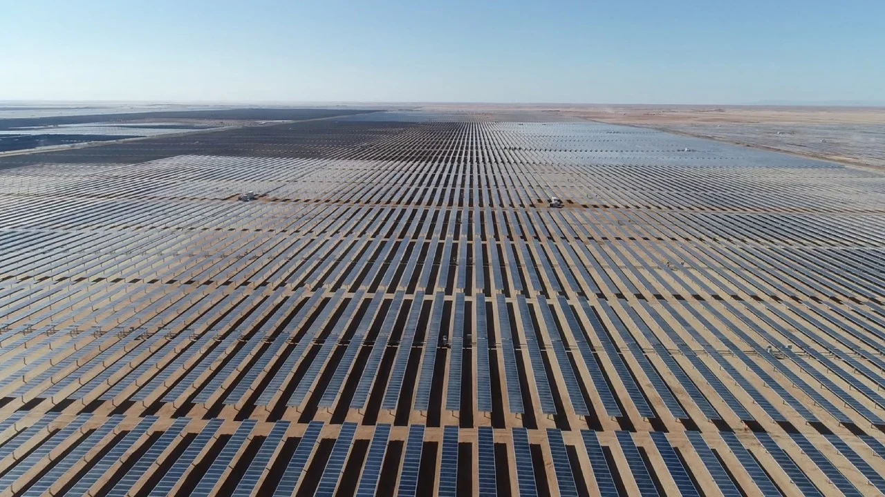 Large scale solar PV array under construction with Spanish corporate branding in a rural US landscape.