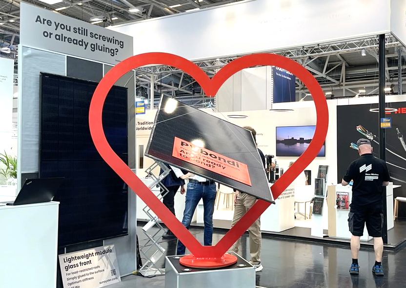 Lightweight PV module with integrated plastic adhesive backing for industrial rooftop installation.