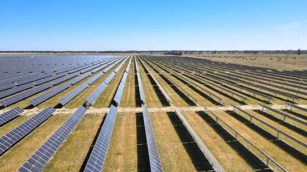 Large scale lithium-ion battery storage containers in a field with power lines