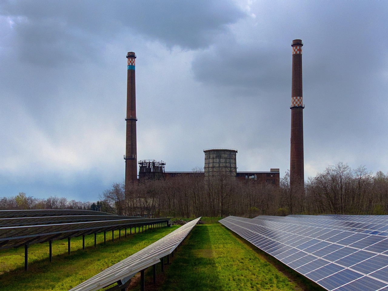 Large scale solar farm integrated with wind turbines and battery storage containers in rural Spain