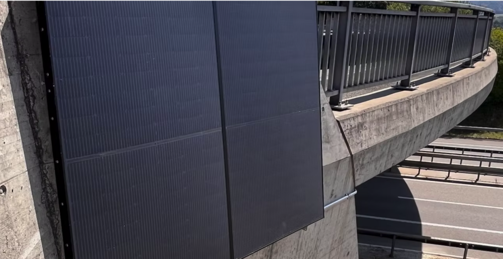 Workers installing vertical bifacial PV solar modules on a European agricultural field