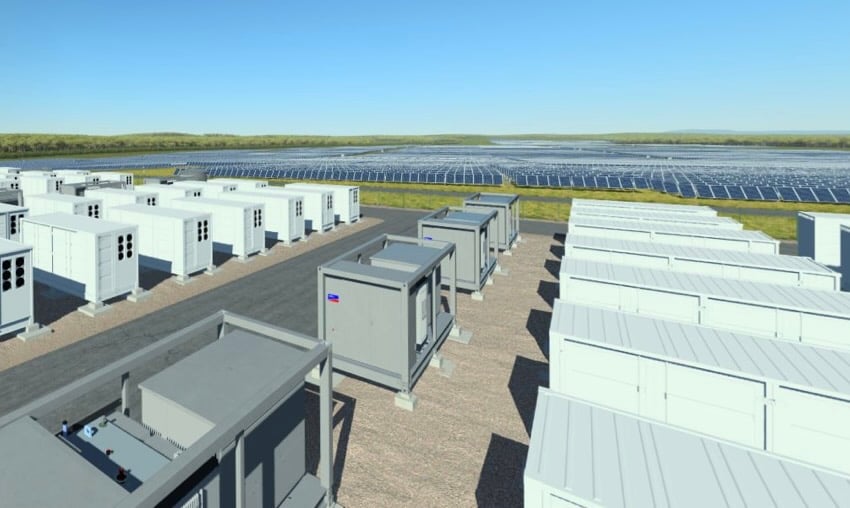 Aerial view of a massive solar array integrated with containerized battery storage systems in a rural landscape.