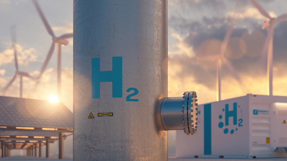 Aerial view of a massive industrial green ammonia and hydrogen production plant in a desert landscape.