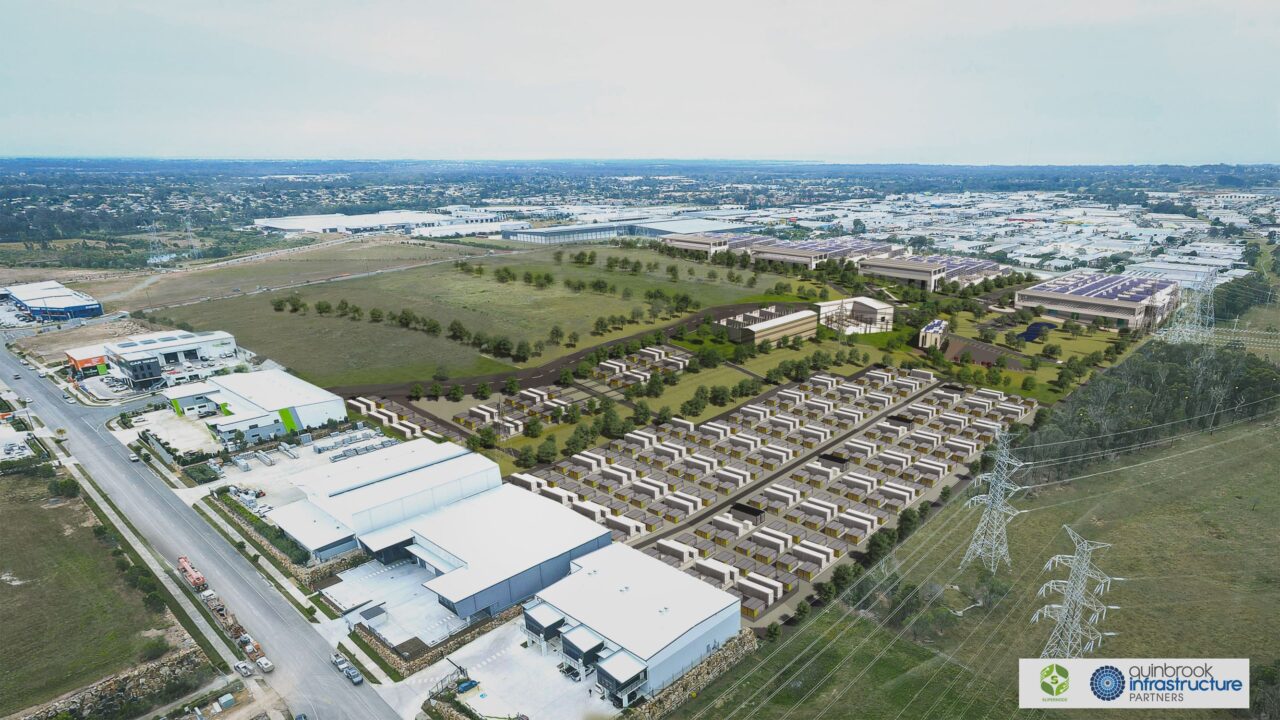A modular Fluence BESS unit installed next to an industrial data center facility.