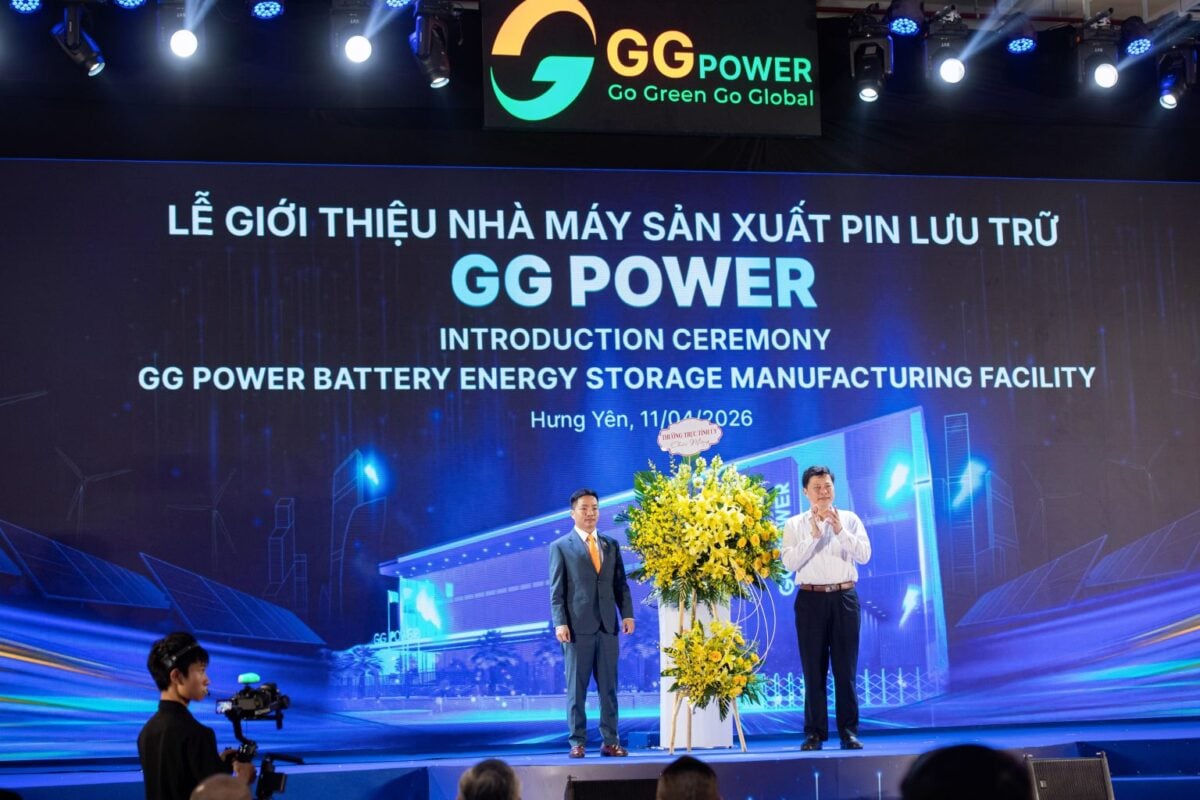 Workers assembling large-scale battery energy storage systems in a modern, high-tech manufacturing facility in Vietnam.