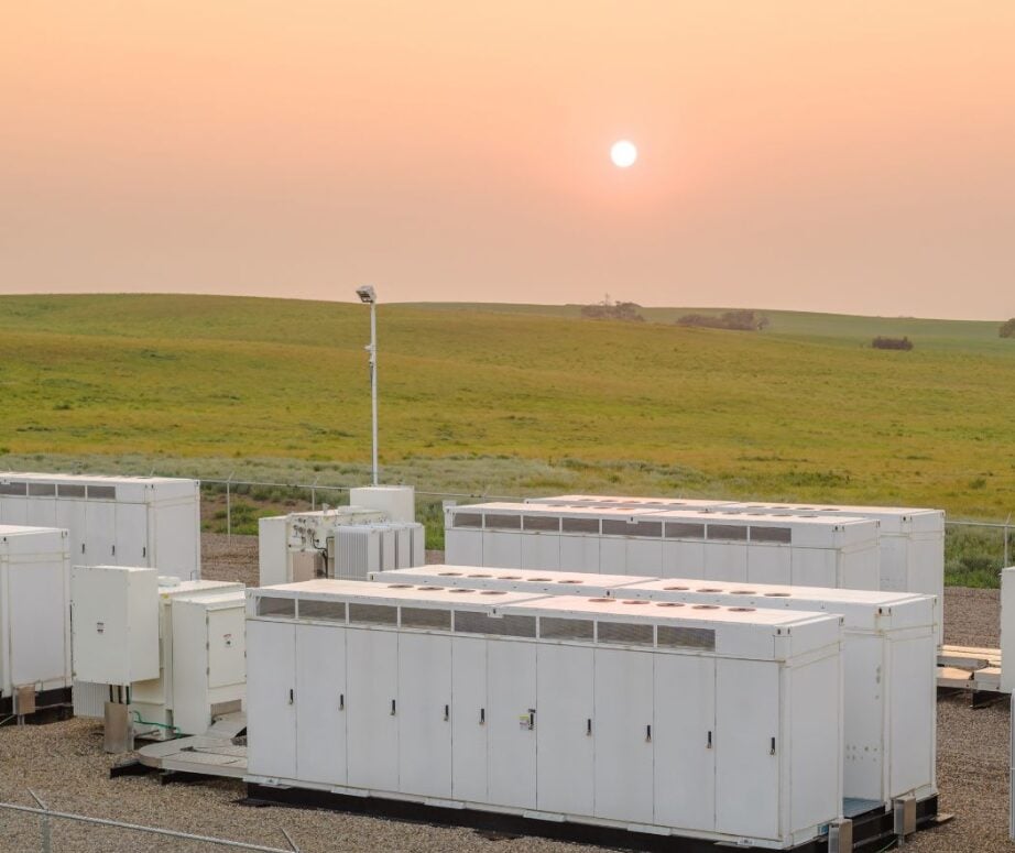 Aerial construction view of a large-scale battery energy storage site with solar arrays.