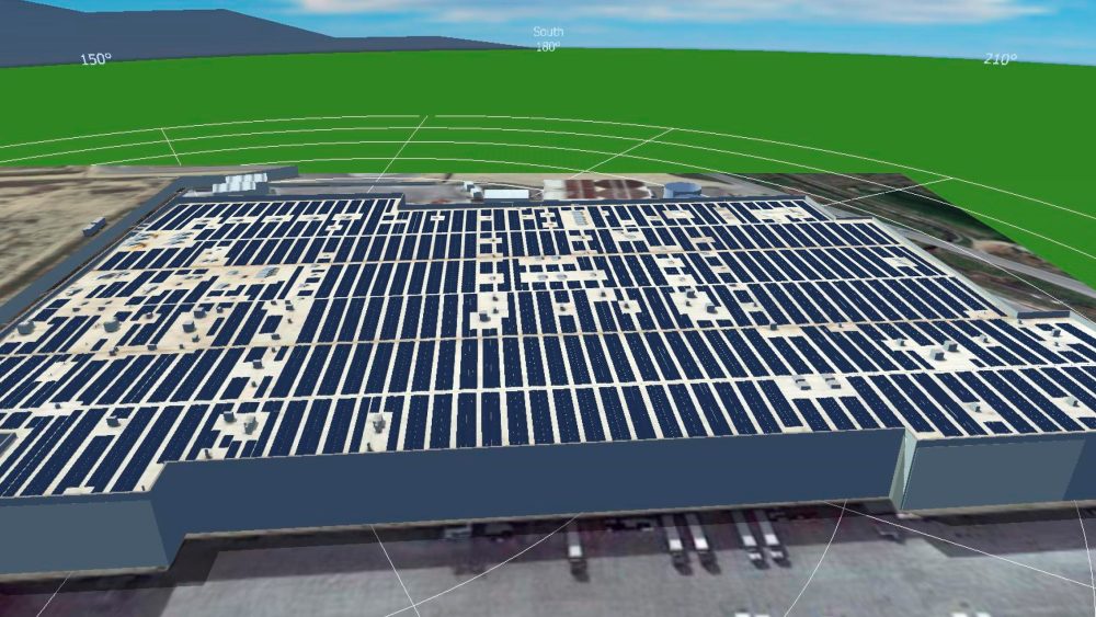 Large scale industrial solar installation with both rooftop and ground-mounted panels at a meat processing plant.