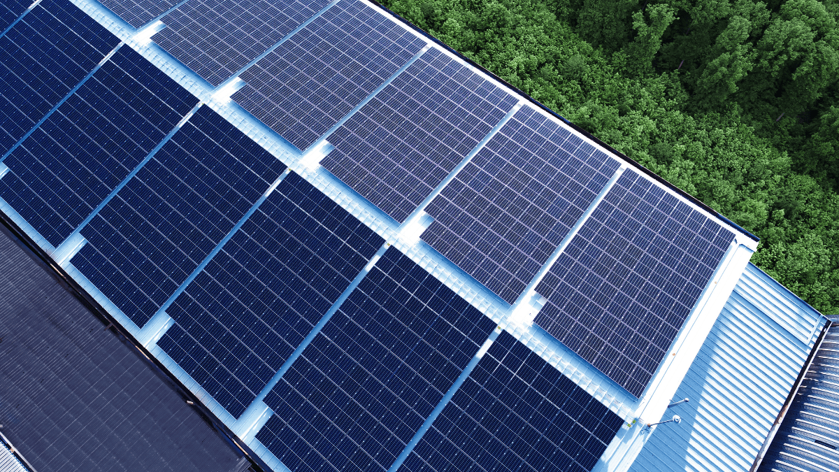 Aerial view of a dense residential area with rooftop solar panels installed on multiple houses.
